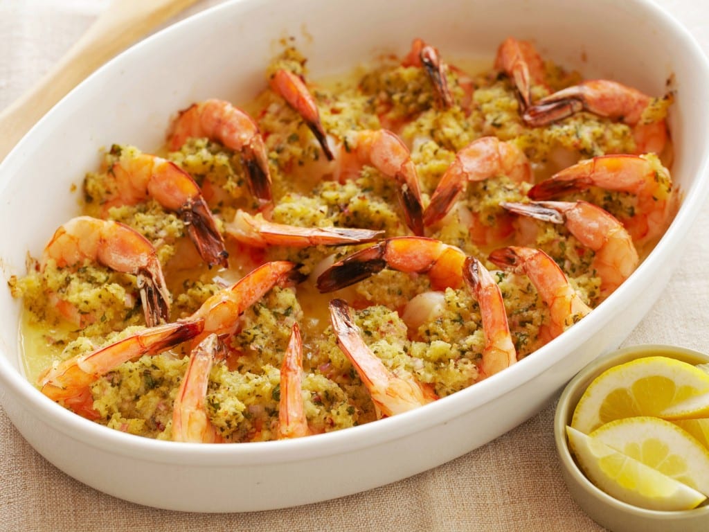 A casserole dish with shrimp and rice in it.