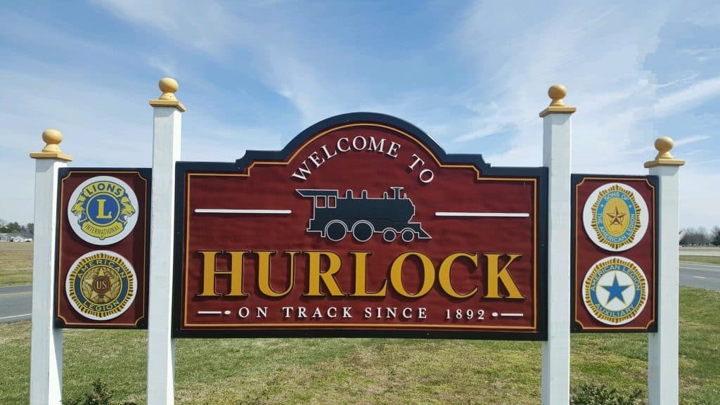 A sign that says welcome to hurlock on track since 1 9 3 2.